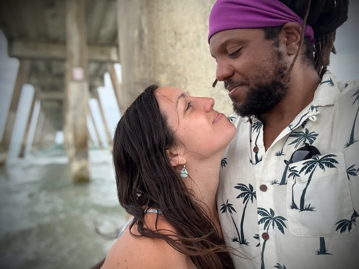 Thomas Edwards with his wife beneath a beach pier